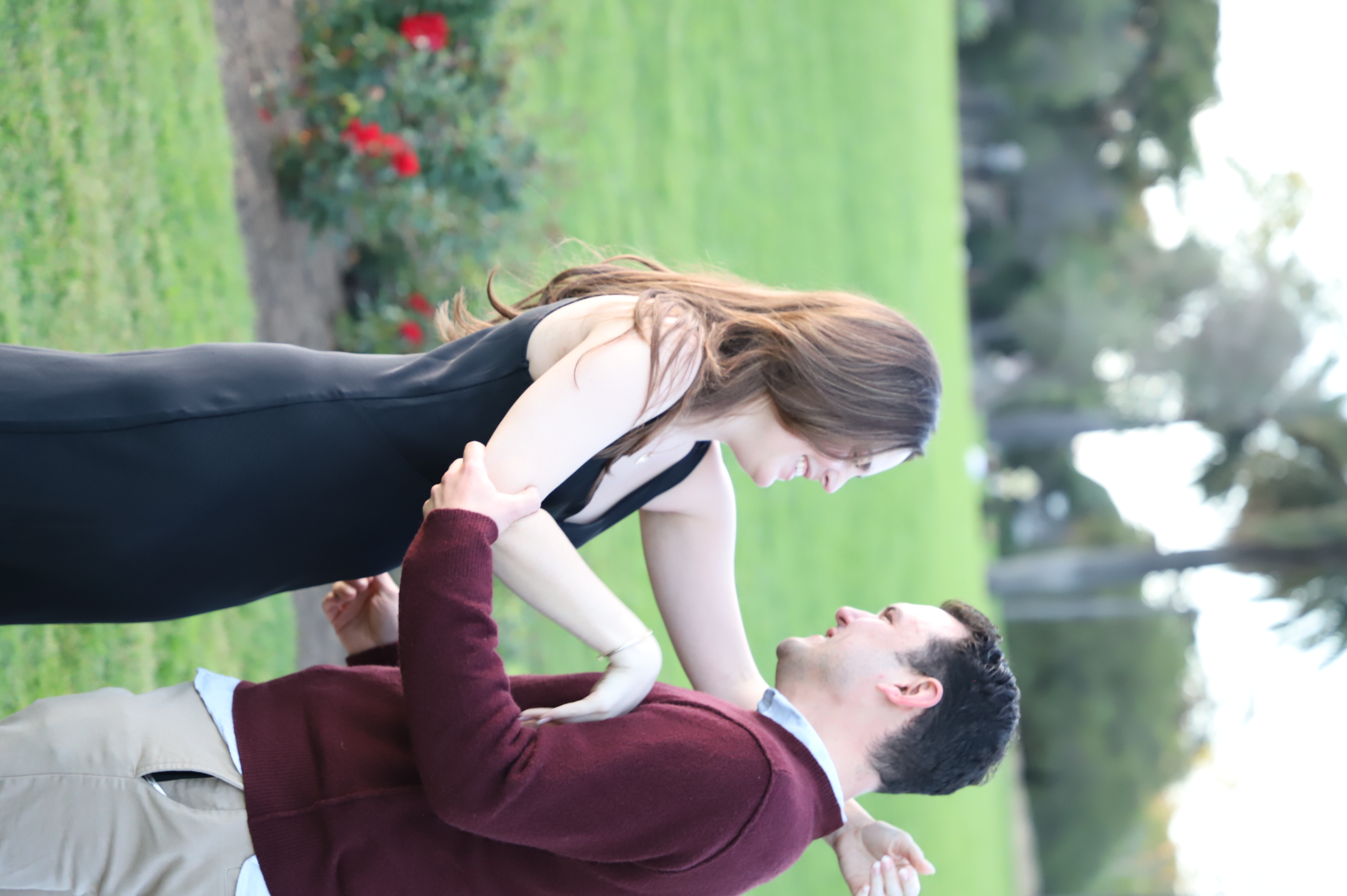 Max lifting Ashley in the rose garden